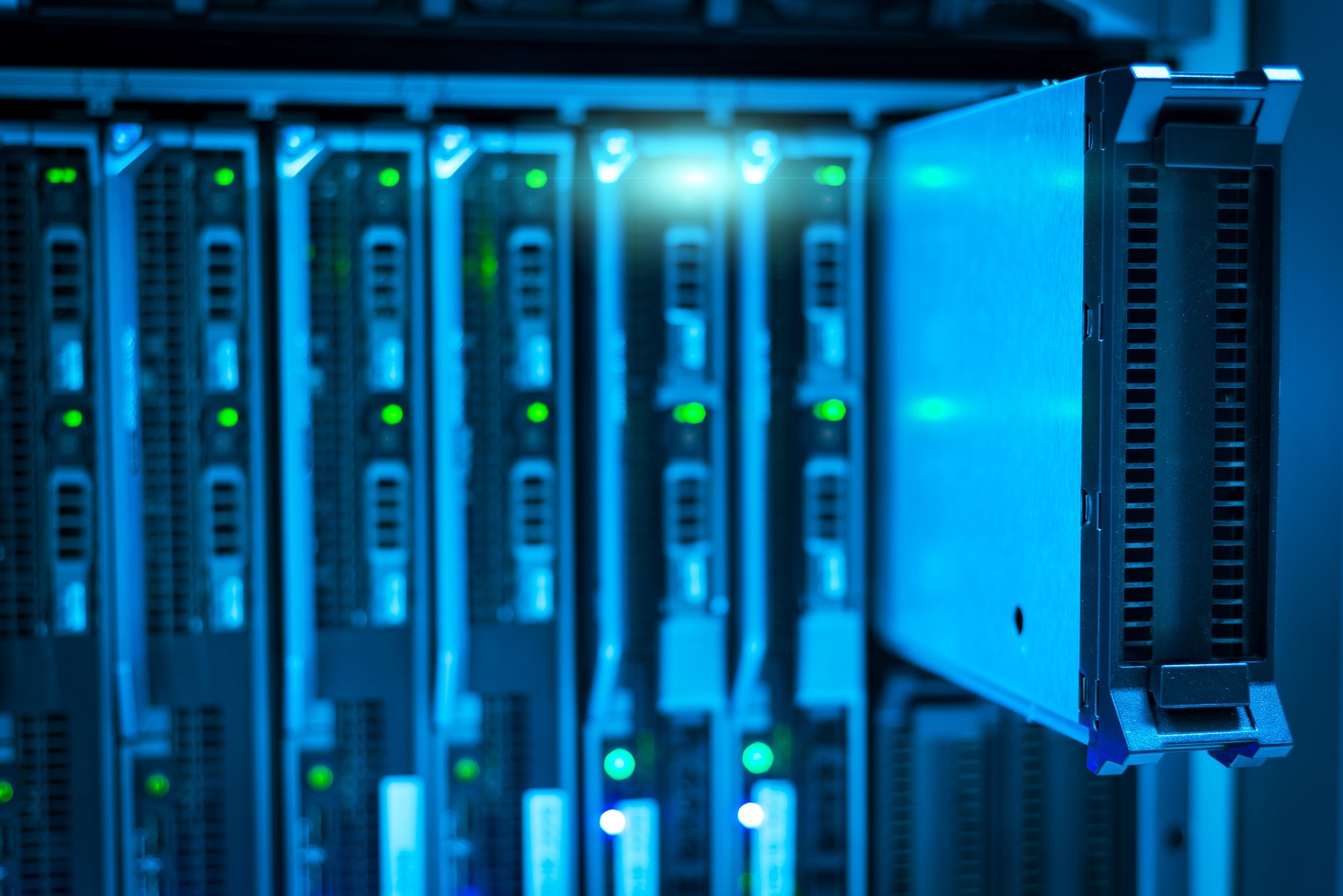 5 Ways Modern Companies Are Cutting Cloud Storage Waste A close-up view of server racks and blades inside a data center illuminated by blue light.